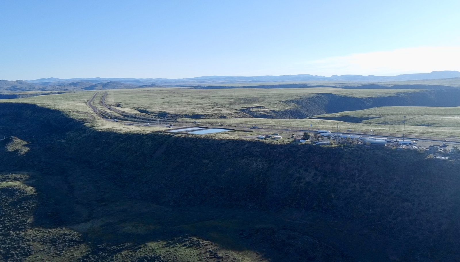 High desert terrain and highway corridor aerial