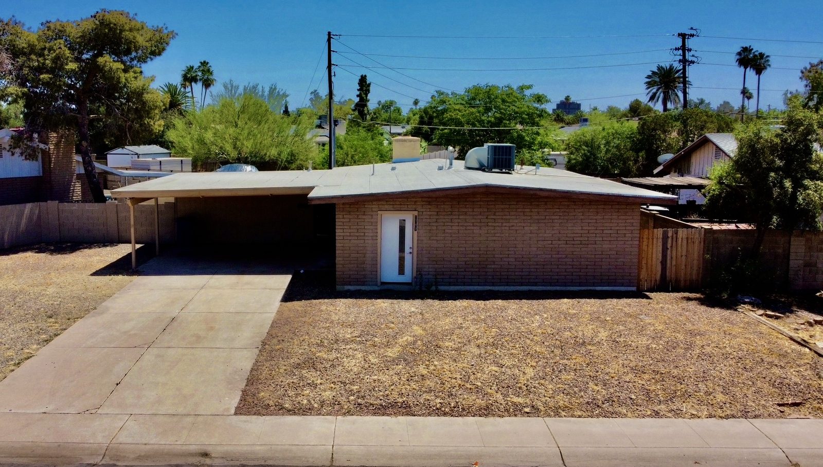 Elevated front view of ranch-style home for listing